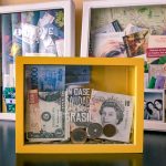 Cofre com moedas e notas de diferentes países.